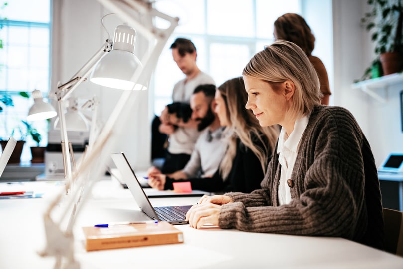 Image of people working at a desk | Benefits with Benify