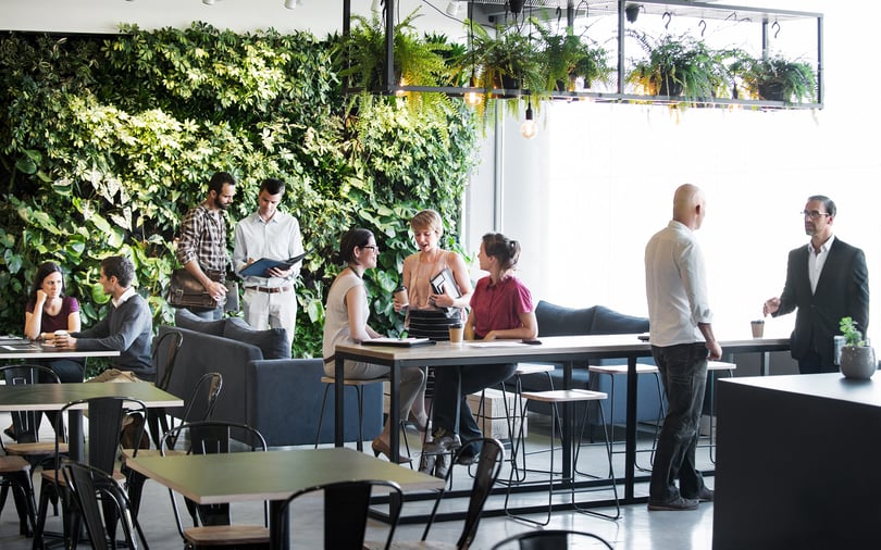 Group of people talking in a breakout space in an office